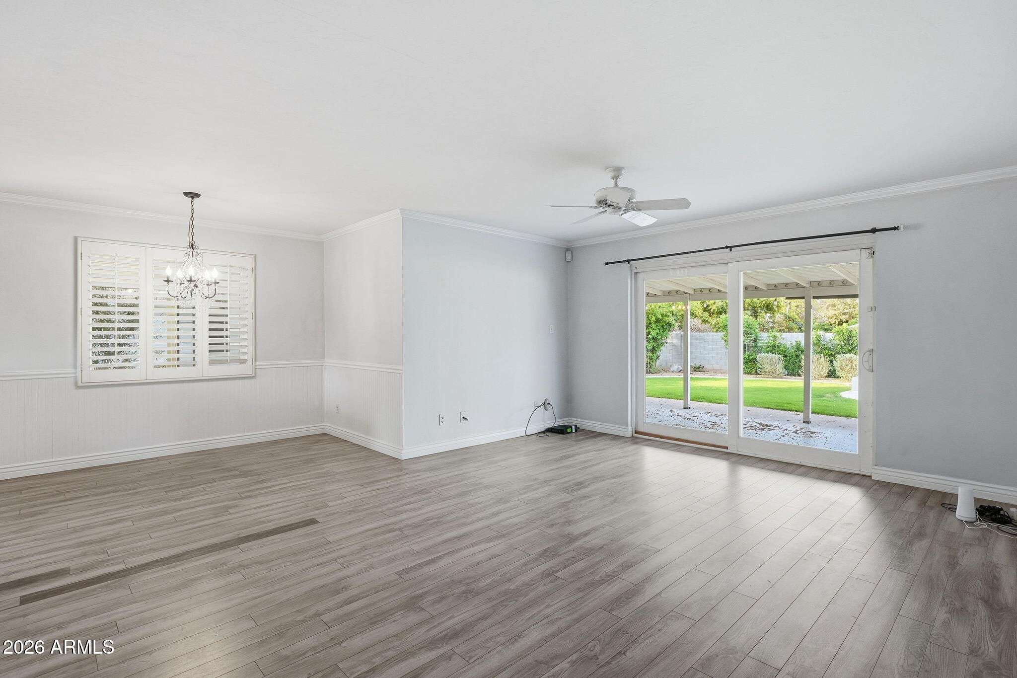 4702 North 30th Place Phoenix, AZ 85016 - Photo 6 of 34 an empty room with wooden floor and windows