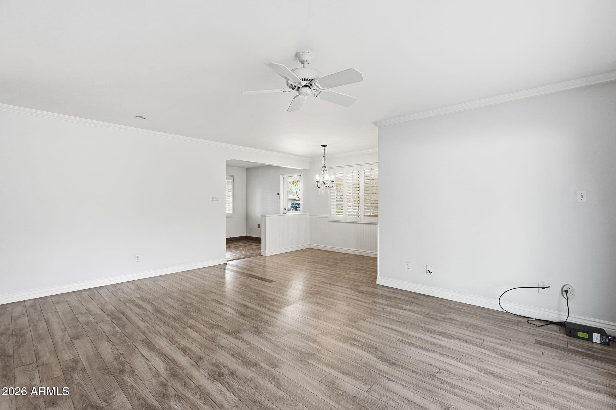 4702 North 30th Place Phoenix, AZ 85016 - Photo 7 of 34 an empty room with wooden floor fan and windows
