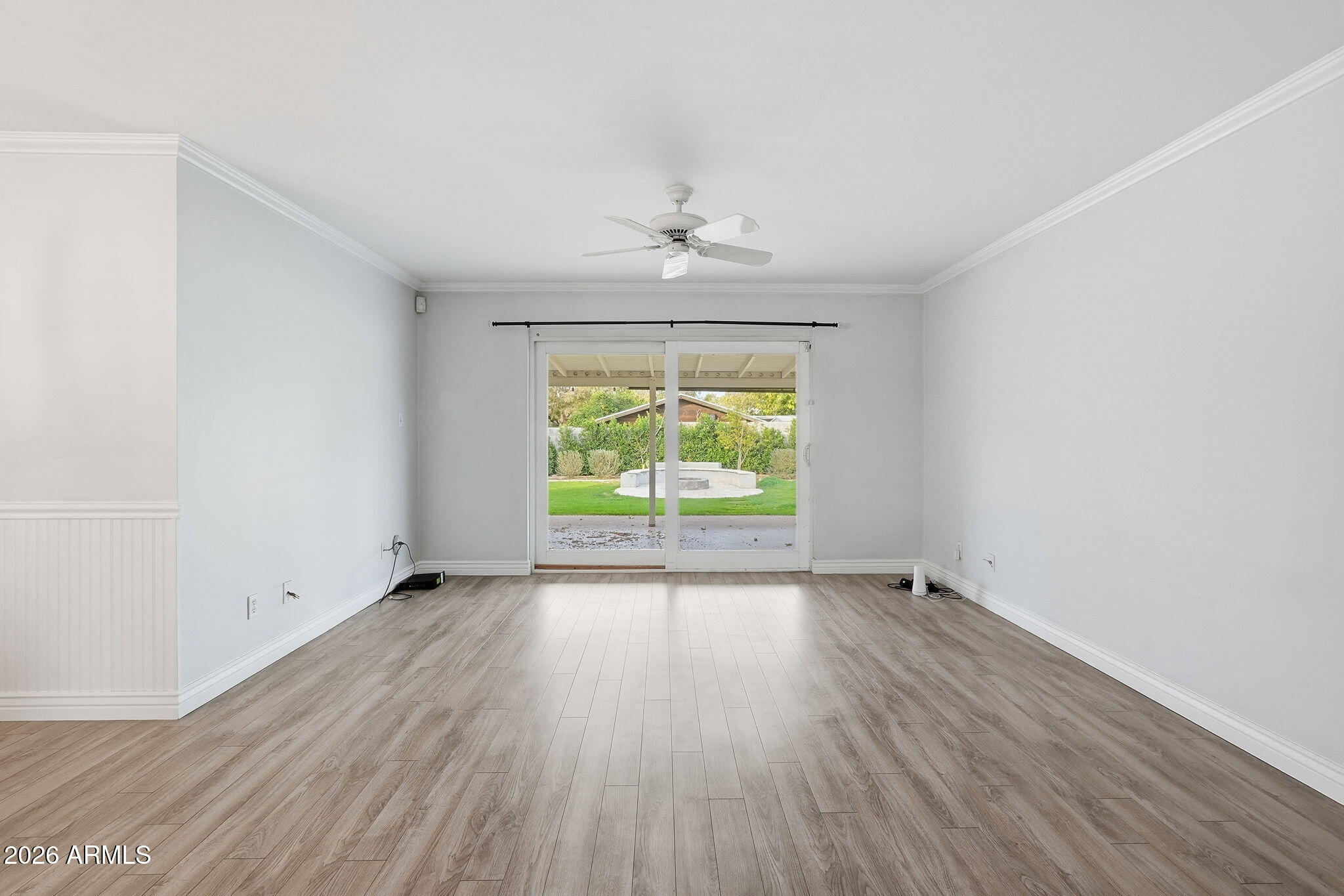 4702 North 30th Place Phoenix, AZ 85016 - Photo 8 of 34 an empty room with wooden floor and windows