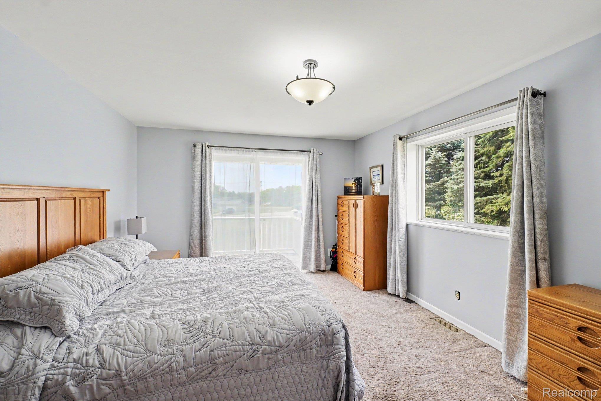 4848 Columbiaville Road Columbiaville, MI 48421 - Photo 8 of 35 Spacious room featuring light gray walls and a neutral-toned carpet