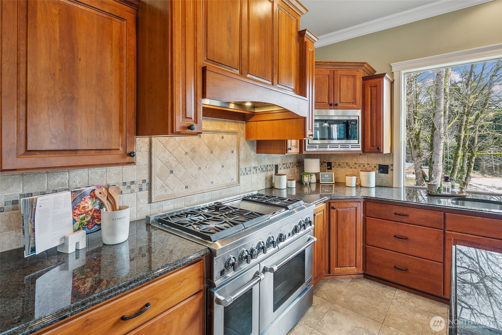 3505 Newberg Road Snohomish, WA 98290 - Photo 8 of 40 a kitchen with stainless steel appliances granite countertop a stove a sink dishwasher and cabinets with wooden floor