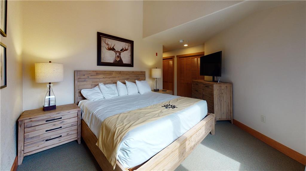 161 Hawk Circle, Unit 2336 Keystone, CO 80435 - Photo 19 of 29 a bedroom with a bed and a flat screen tv