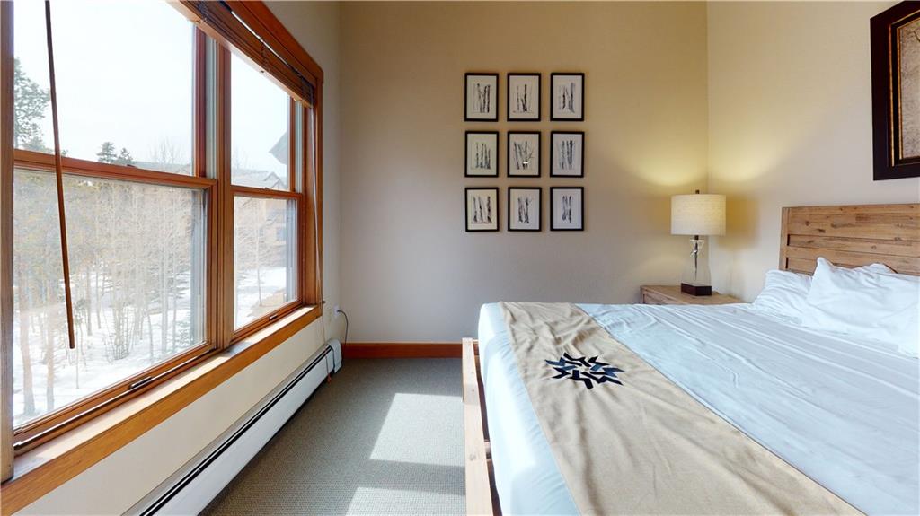 161 Hawk Circle, Unit 2336 Keystone, CO 80435 - Photo 22 of 29 a bedroom with a bed and a large window