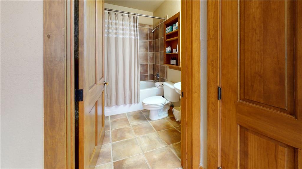 161 Hawk Circle, Unit 2336 Keystone, CO 80435 - Photo 24 of 29 a bathroom with a toilet and a shower curtain