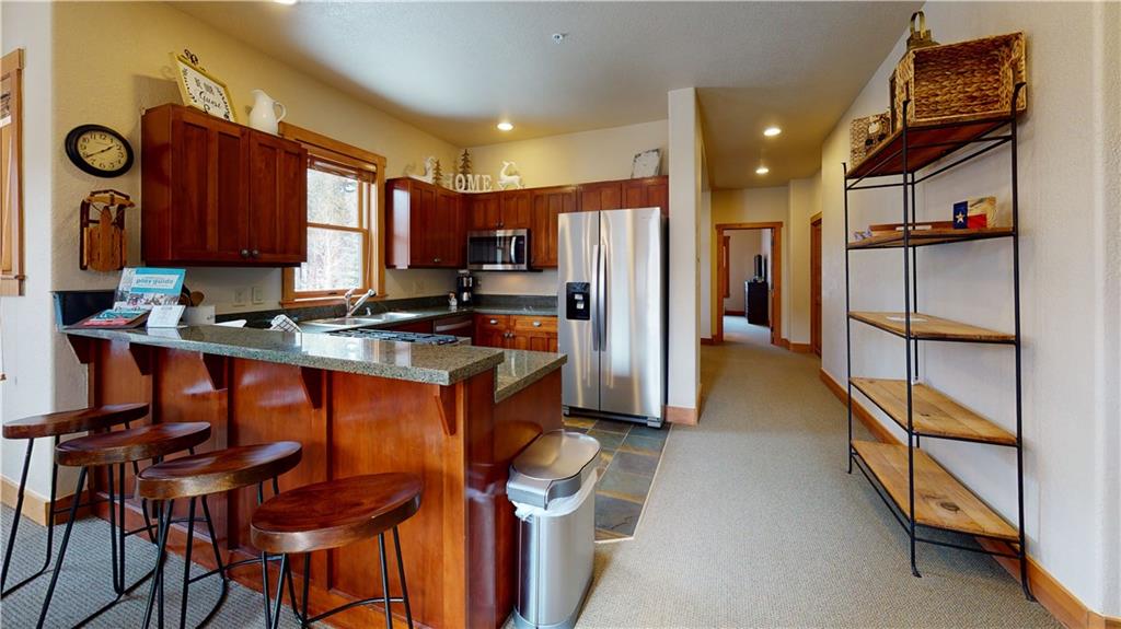 161 Hawk Circle, Unit 2336 Keystone, CO 80435 - Photo 5 of 29 a kitchen with stainless steel appliances granite countertop a refrigerator and a stove top oven