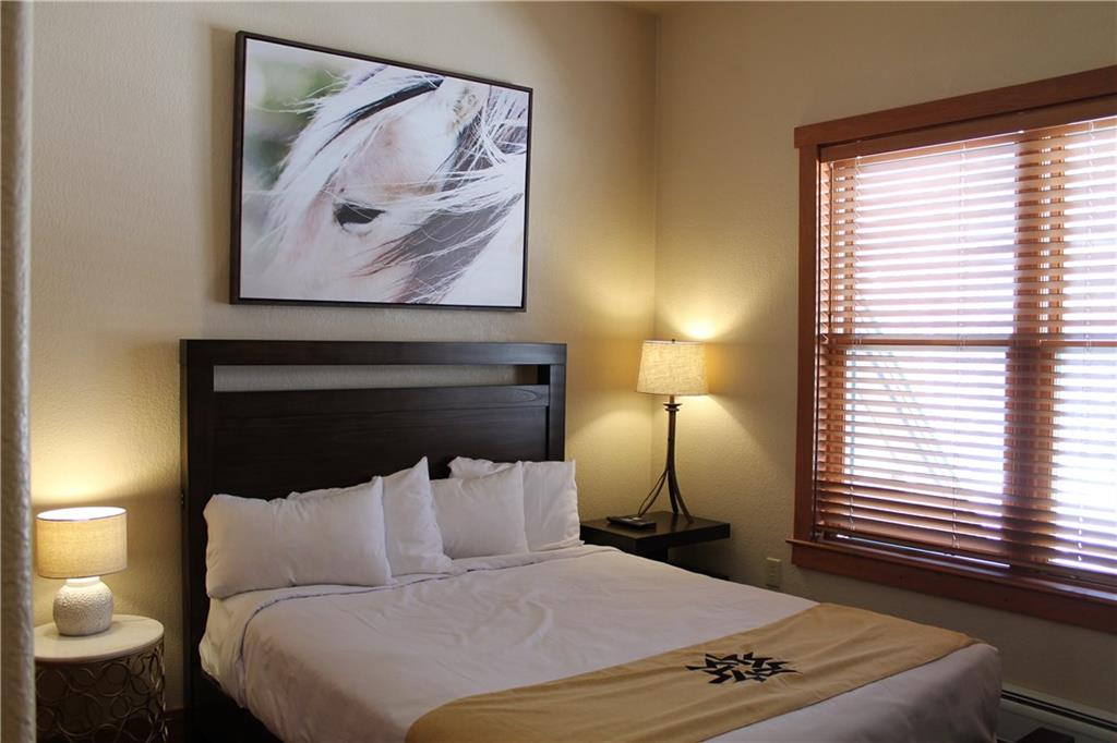 161 Hawk Circle, Unit 2336 Keystone, CO 80435 - Photo 10 of 29 a bed room with a bed and a night stand