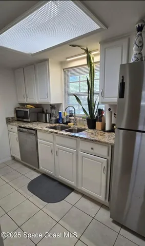 a kitchen with a sink appliances and cabinets