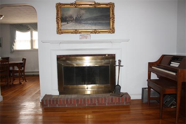65 Westvale Road Milton, MA 02186 - Photo 5 of 20 a living room with furniture and a fireplace