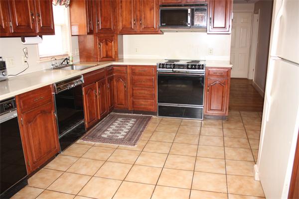 65 Westvale Road Milton, MA 02186 - Photo 10 of 20 a kitchen with stainless steel appliances granite countertop a stove a sink and a microwave