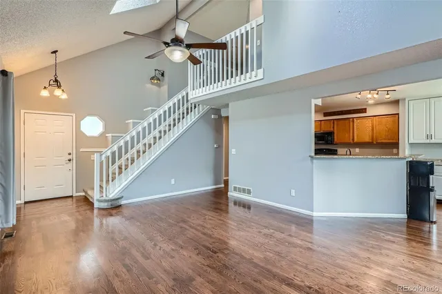 a view of entryway and hall with wooden floor