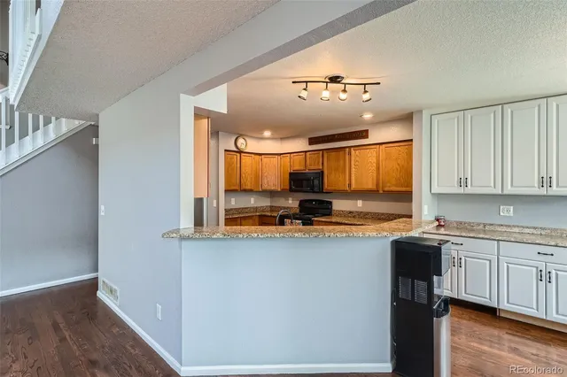 a kitchen with stainless steel appliances granite countertop a sink and cabinets