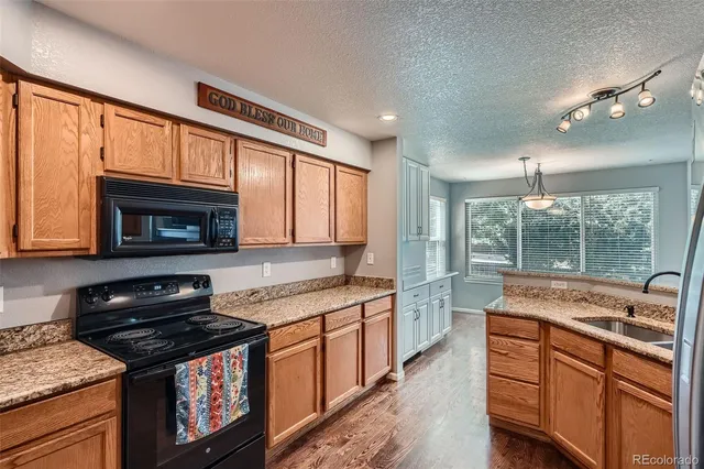 a kitchen with stainless steel appliances granite countertop stove a sink and a microwave