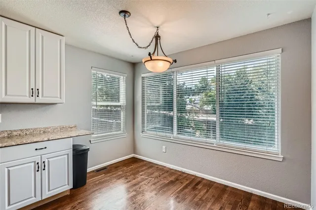a kitchen that has a lot of windows and cabinets