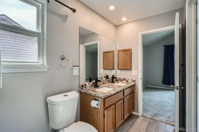 a bathroom with a toilet sink and mirror