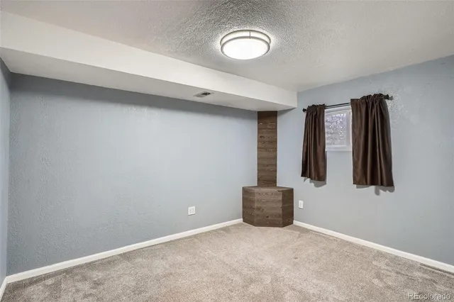 an empty room with windows and closet