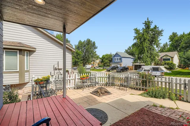 a backyard of a house with table and chairs
