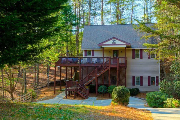 a open kitchen with stainless steel appliances granite countertop a stove top oven a sink dishwasher a dining table and chairs with wooden floor