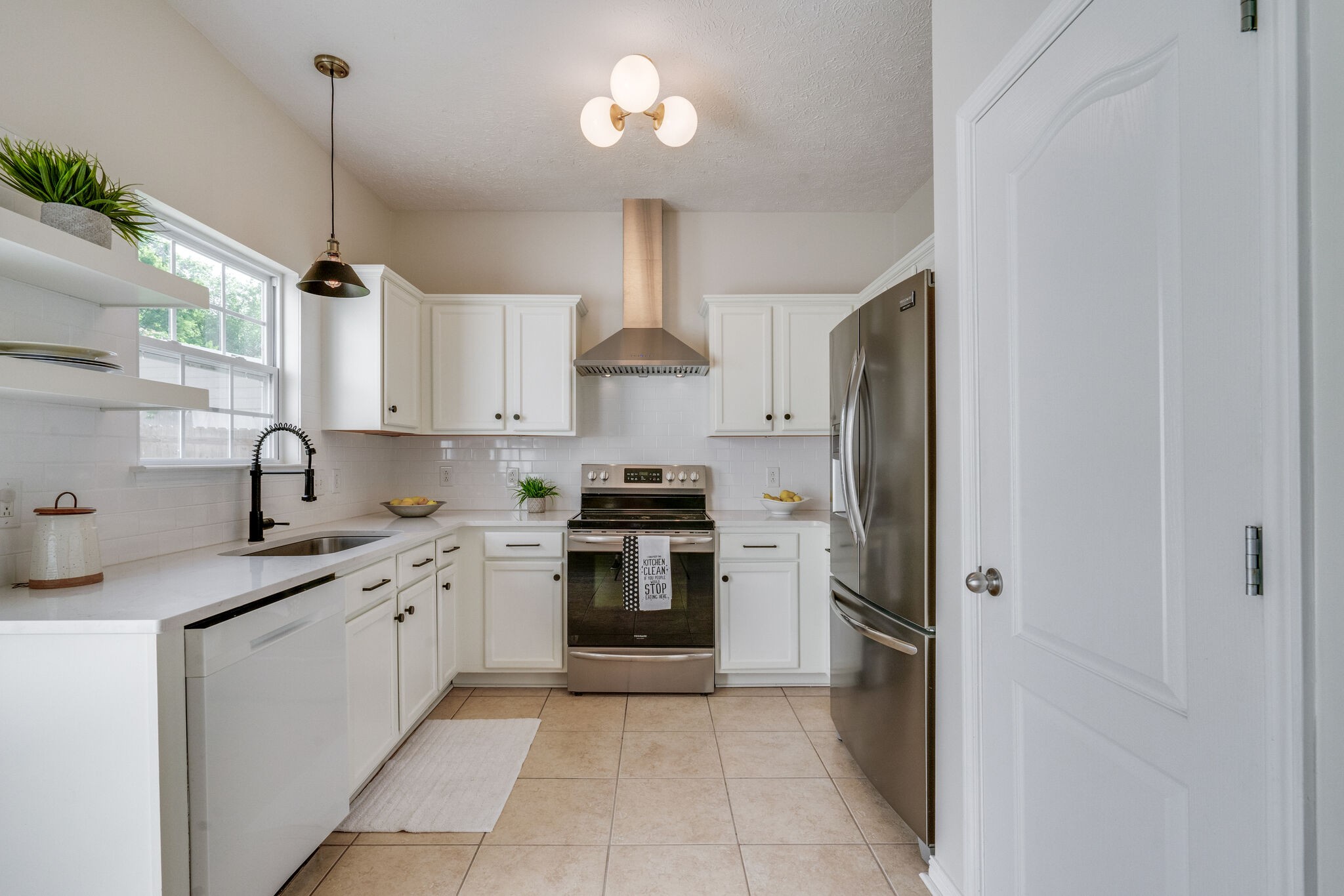 306 Cherry Drive Franklin, TN 37064 - Photo 8 of 30 a kitchen with stainless steel appliances granite countertop a sink a stove and a refrigerator