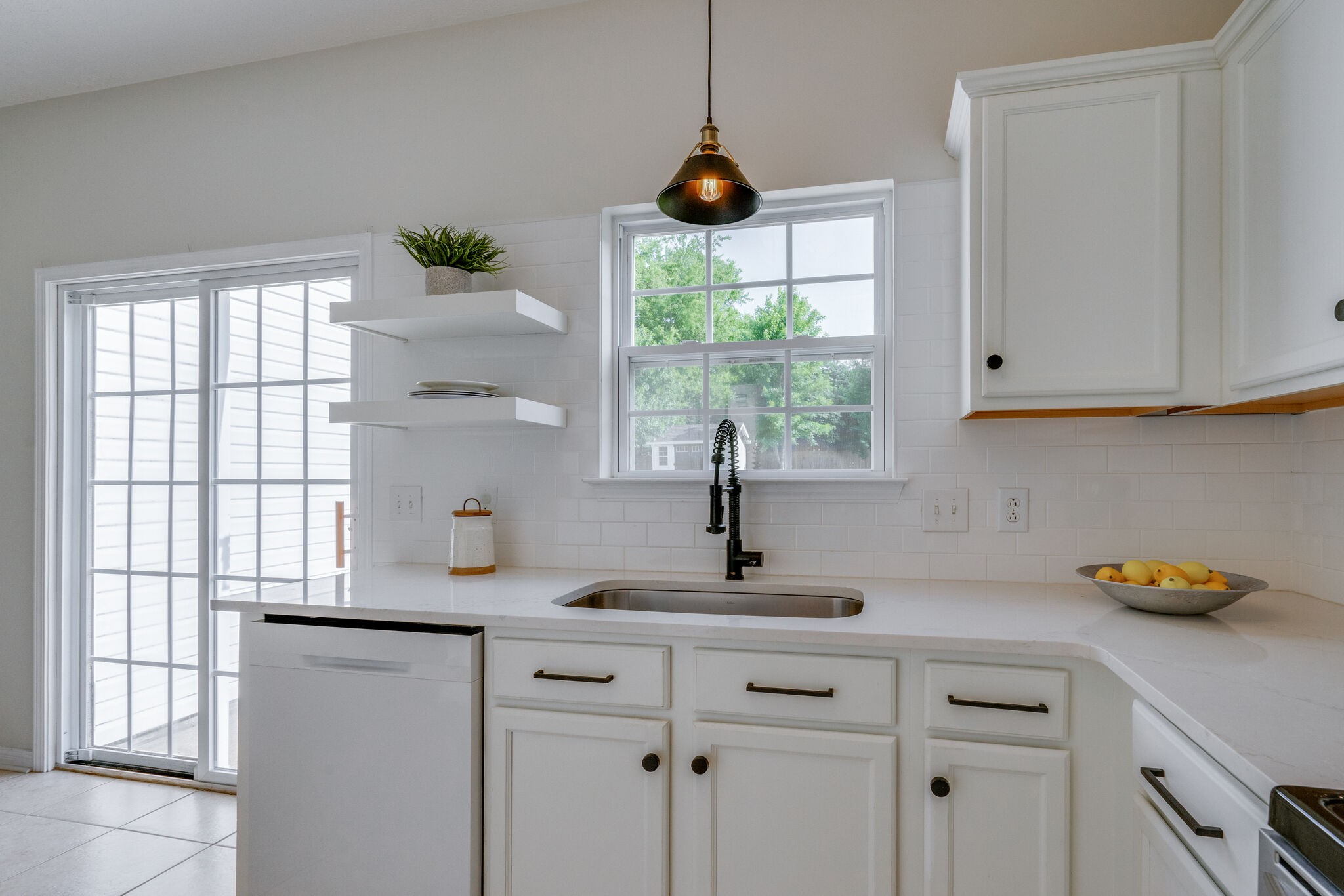 306 Cherry Drive Franklin, TN 37064 - Photo 10 of 30 a kitchen with stainless steel appliances granite countertop a sink a window and white cabinets