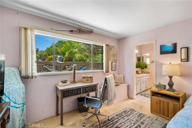 a bathroom with a sink a mirror and a potted plant