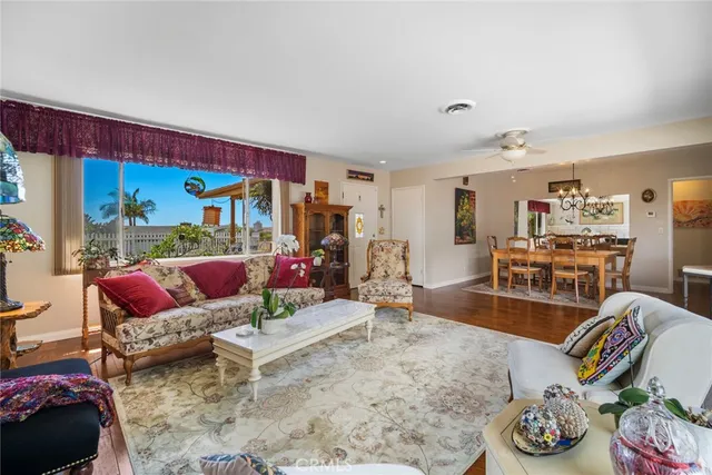 a view of a dining room with furniture and a chandelier