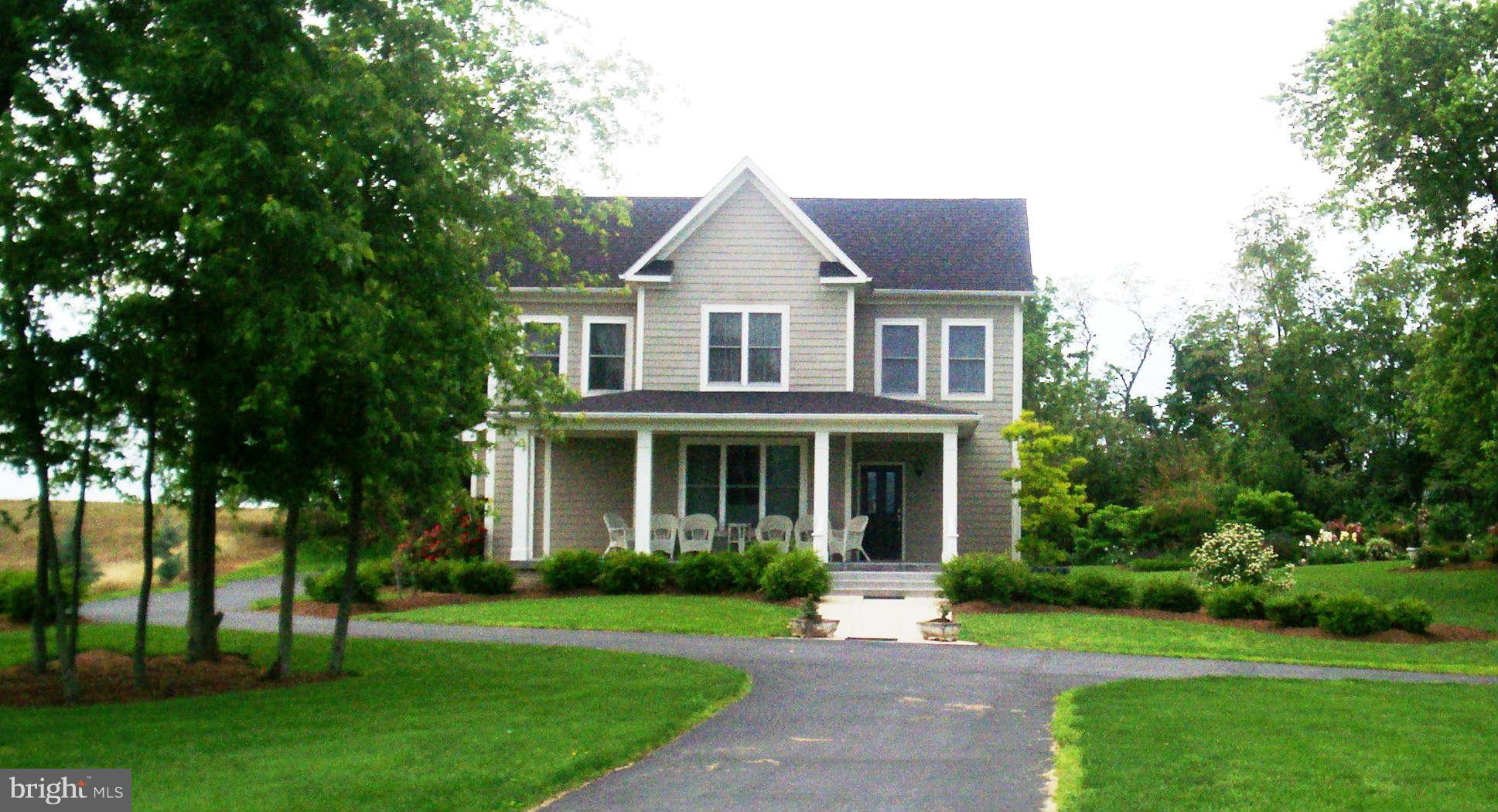 2985 Kabletown Road Charles Town, WV 25414 - Photo 2 of 22 a front view of a house with a yard and trees