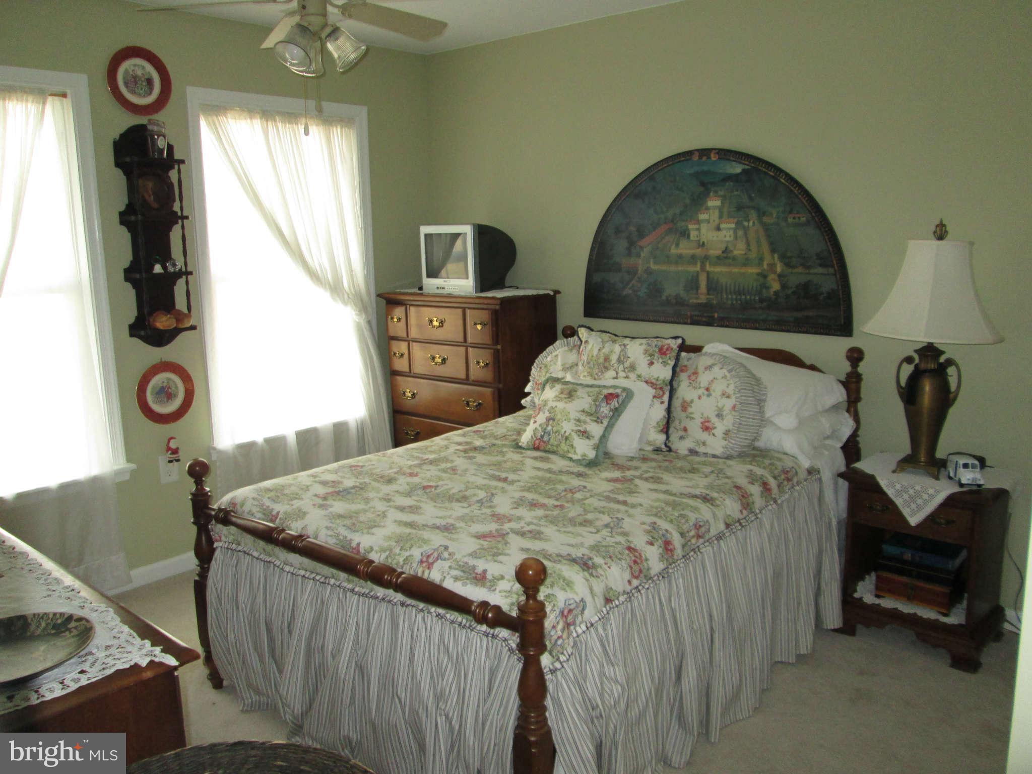2985 Kabletown Road Charles Town, WV 25414 - Photo 12 of 22 a bedroom with a bed and a mirror on the dresser