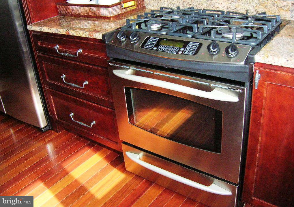 2985 Kabletown Road Charles Town, WV 25414 - Photo 22 of 22 a stove top oven sitting inside of a kitchen