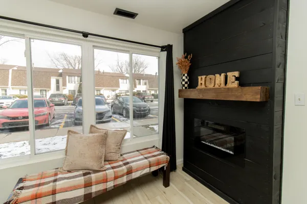 a living room with furniture and a floor to ceiling window