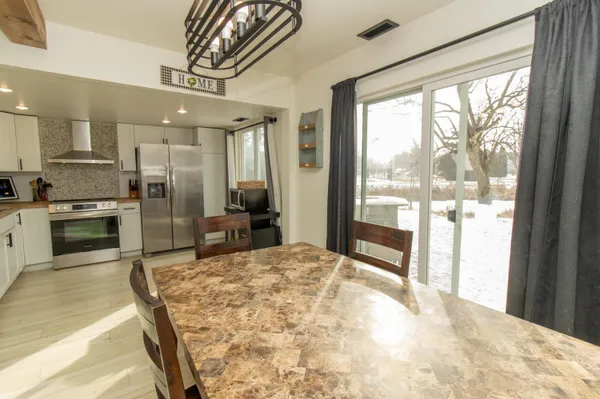 a large kitchen with a large window and stainless steel appliances