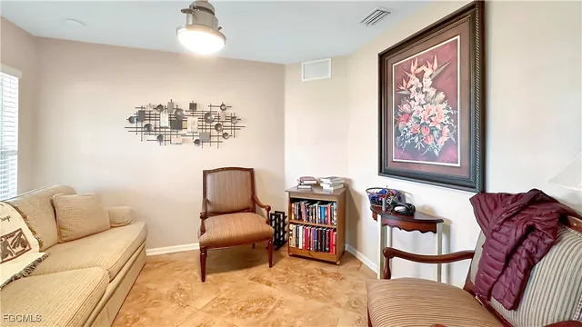 a living room with furniture cabinets and window