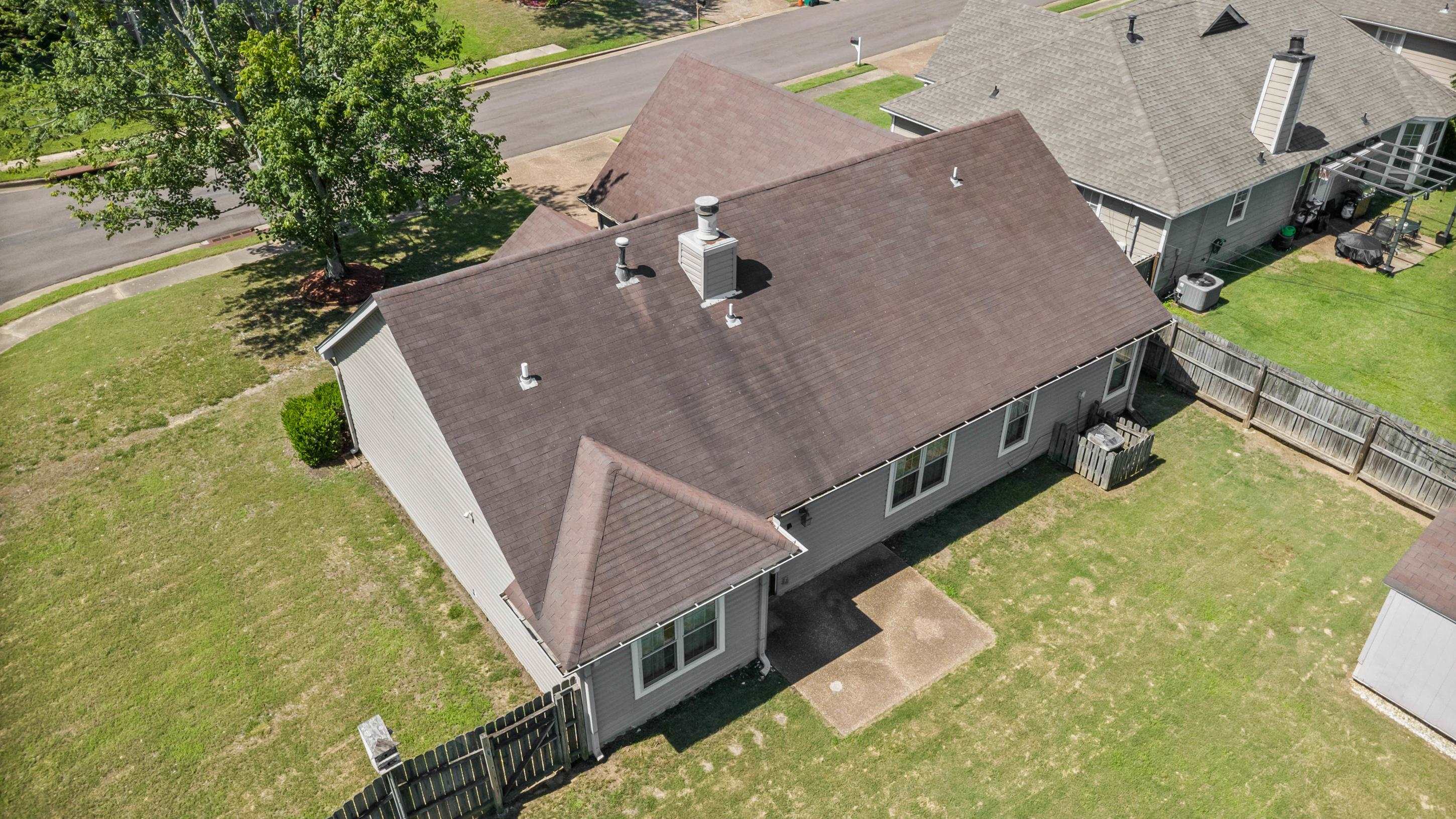 7130 Bryan Station Road Cordova, TN 38018 - Photo 25 of 26 Aerial perspective showcasing the property's roofline, a detached storage shed, and a privacy fence