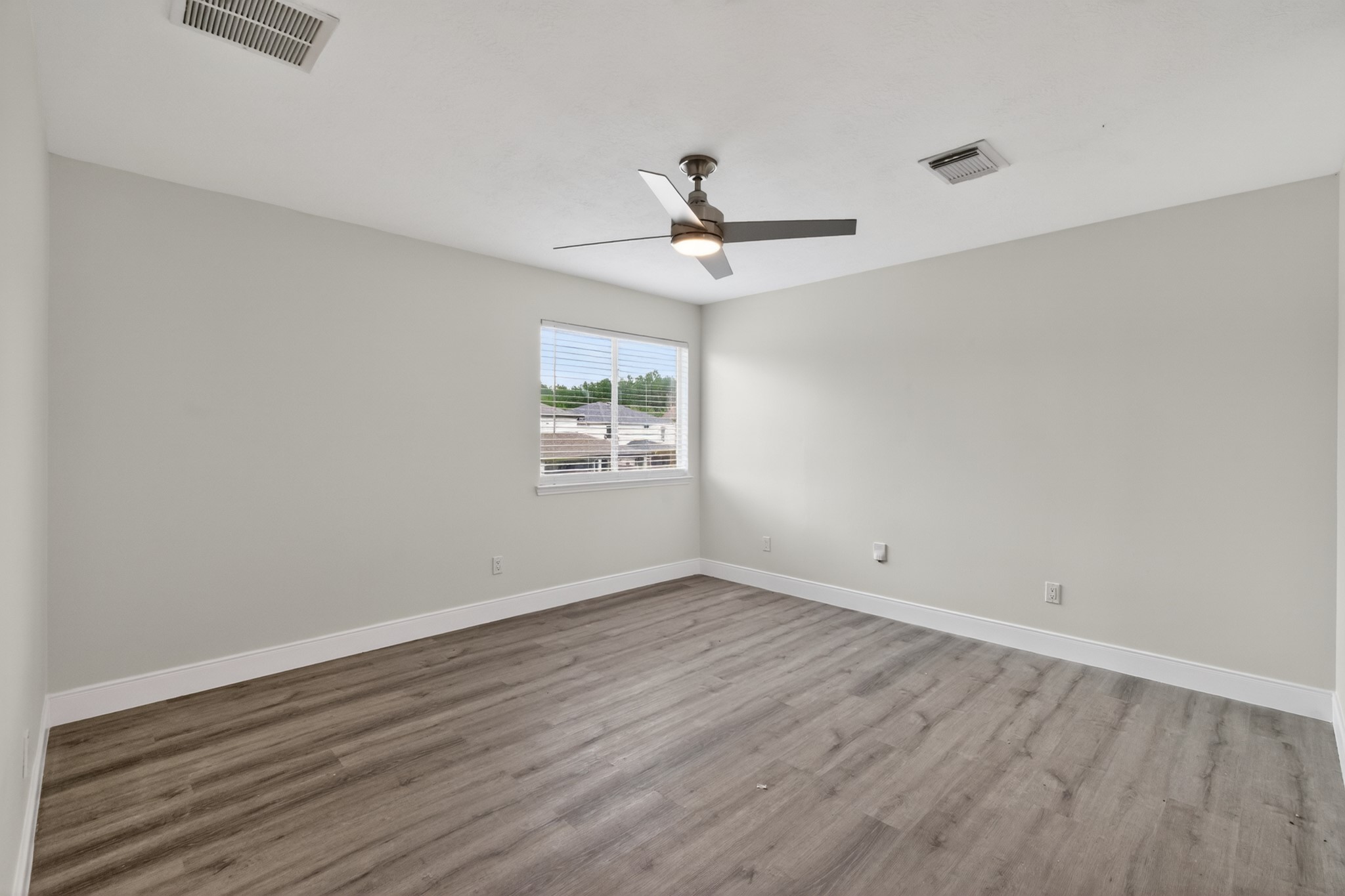 918 Ivycroft Lane Spring, TX 77373 - Photo 18 of 33 an empty room with wooden floor ceiling fan and windows