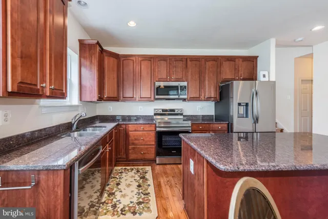 a view of a livingroom with wooden floor and a fireplace