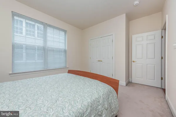 a bathroom with a granite countertop toilet sink and mirror