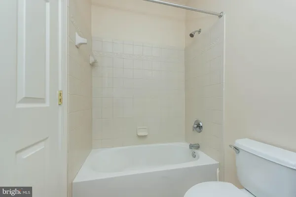 a spacious bedroom with a bed and a large window