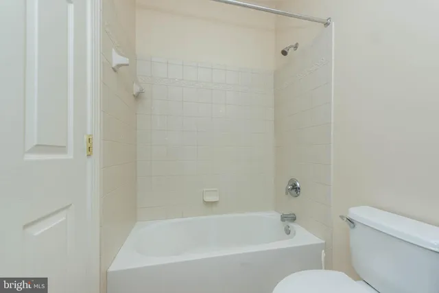 a spacious bedroom with a bed and a large window