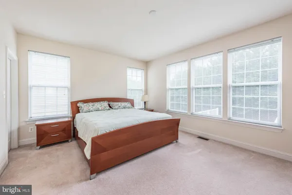 a bedroom with a large bed and a dresser