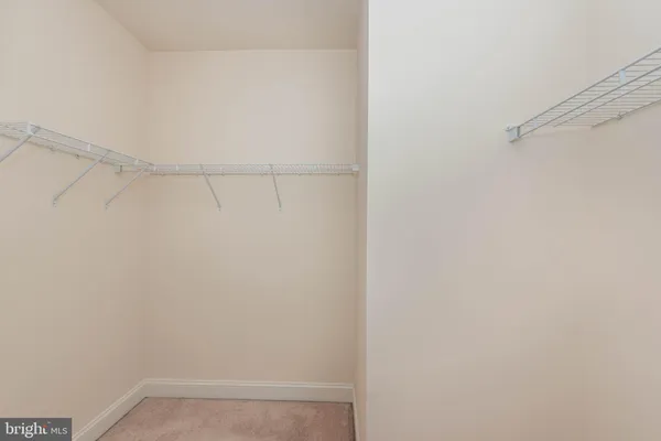a spacious bathroom with a tub sink and mirror