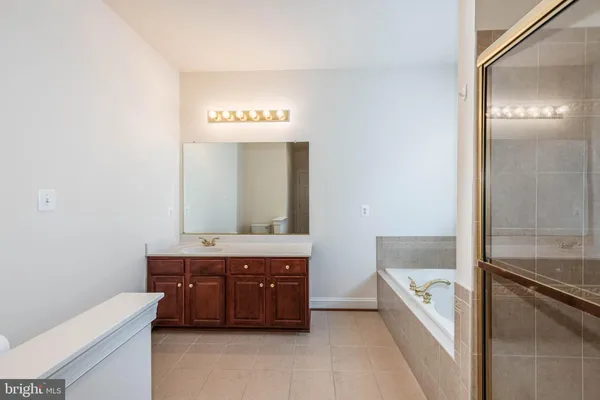 a bathroom with a tub and a window