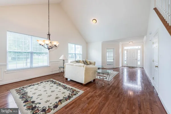 a living room with a couch and wooden floor