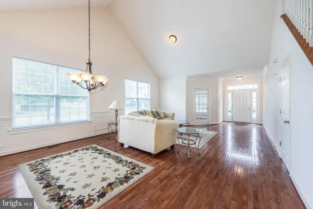 a living room with a couch and wooden floor
