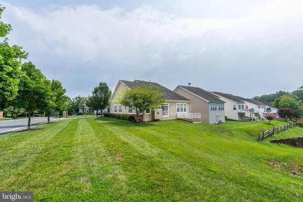 a view of house with yard and green space