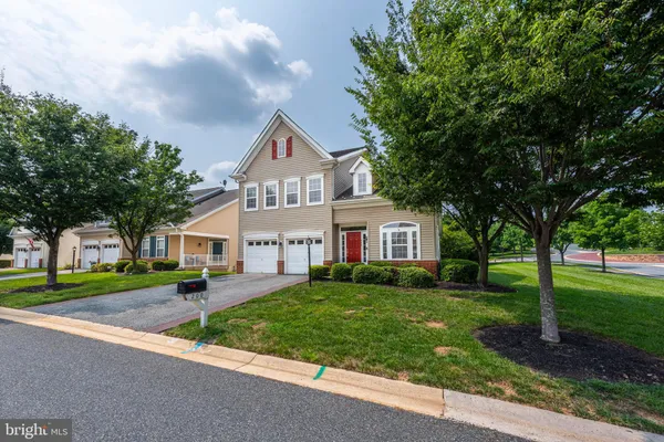 a living room with furniture a chandelier and a large mirror