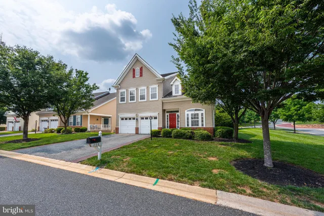 a living room with furniture a chandelier and a large mirror