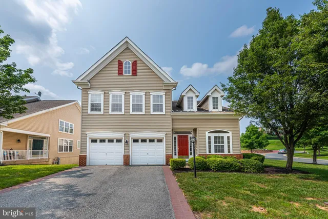 a living room with furniture a flat screen tv and a floor to ceiling window