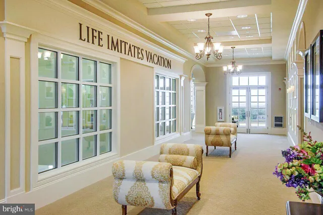 a large white kitchen with a large island in the center