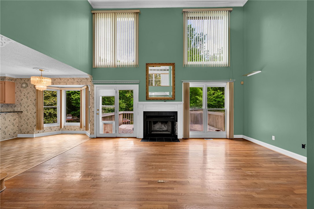1016 Campbell Road Belton, SC 29627 - Photo 6 of 50 Natural light floods this spacious gathering area, featuring a grand fireplace and direct deck access.