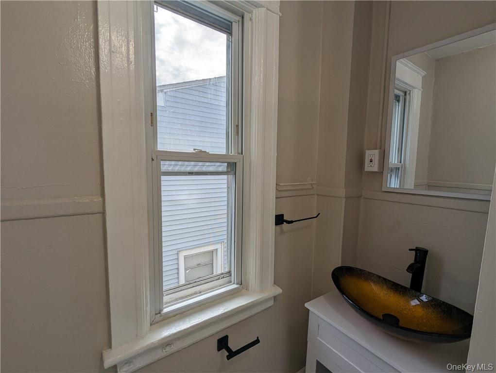 65 Academy Street, Unit 7 Poughkeepsie, NY 12601 - Photo 11 of 19 a bathroom with a sink and a window