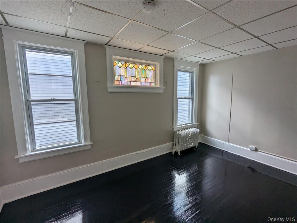 65 Academy Street, Unit 7 Poughkeepsie, NY 12601 - Photo 12 of 19 a view of an empty room with wooden floor and a window